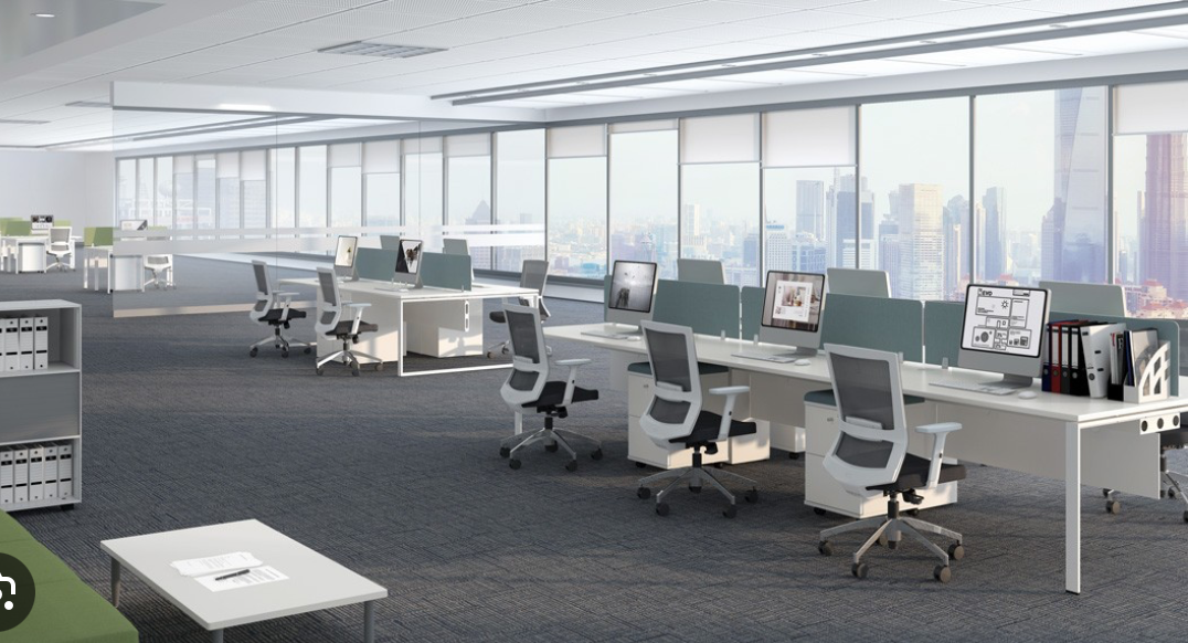 The image is of an office with several computers. The scene includes furniture like tables and desks, office chairs, and a closet. There are also windows, walls, and a ceiling visible in the room.